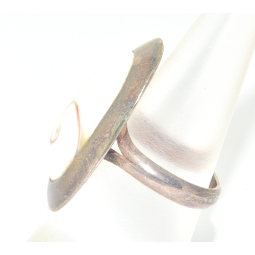 820 - 925 silver large oval white stone with centre twist design held in an enclosed setting size M