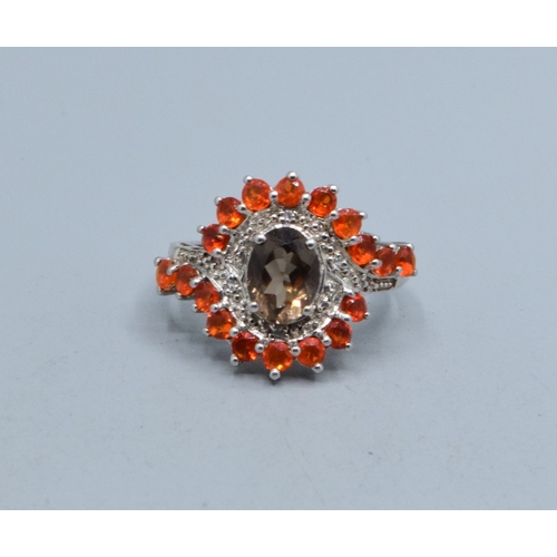771 - Superior 925 silver ladies Grossular Garnet and accent Diamond large halo sweep ring with a central ... 