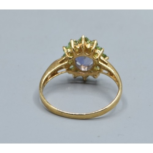 544 - 9ct gold ladies Amethyst and green Peridot halo design ring size N, 2.2grams