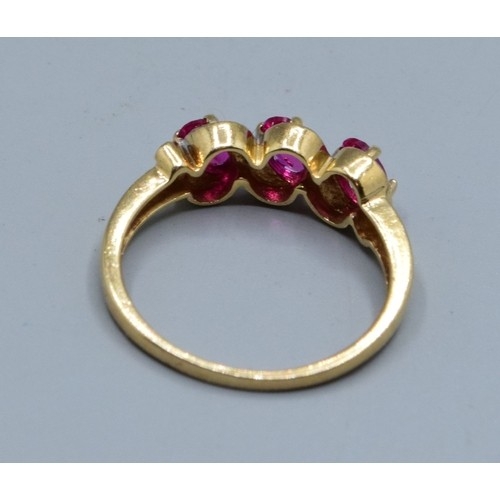 552 - 9ct gold ladies triple Ruby and Diamond gem set halo twist ring hallmarked as Diamond size N,