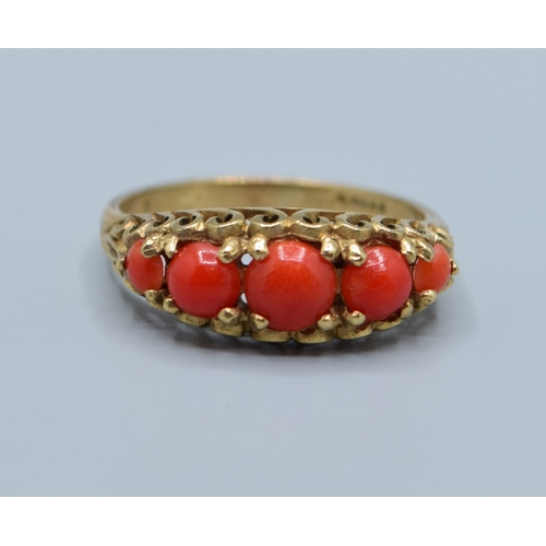 505 - Vintage 9ct gold 5 stone Coral ring held in an open work scroll design size P, 2.9grams