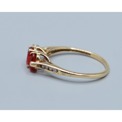 511 - 9ct gold ladies enhanced Ruby 3 stone dress ring with accent Diamond decoration to the shoulders siz... 