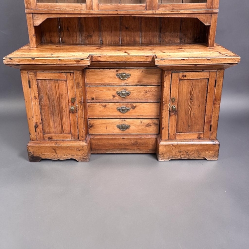 1 - A 19th century glazed Pine farmhouse dresser.Three glazed panels to top above twin cupboards and fou... 
