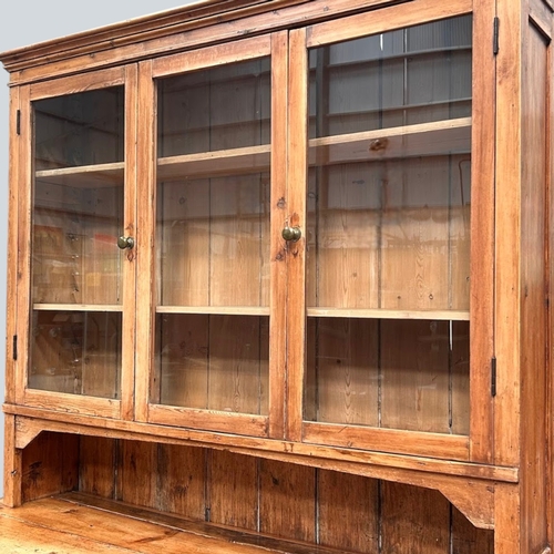 1 - A 19th century glazed Pine farmhouse dresser.Three glazed panels to top above twin cupboards and fou... 