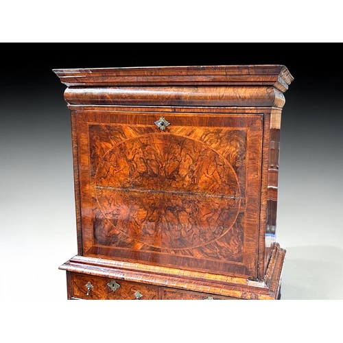 3 - A Queen Anne Walnut drop front escritoire.Stepped moulded cornice above a long drawer, with fall fro... 
