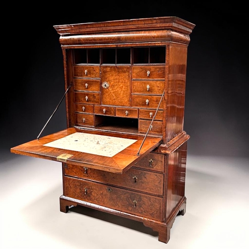 3 - A Queen Anne Walnut drop front escritoire.Stepped moulded cornice above a long drawer, with fall fro... 