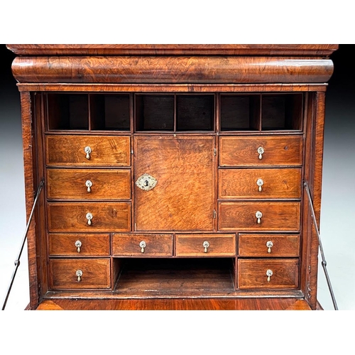 3 - A Queen Anne Walnut drop front escritoire.Stepped moulded cornice above a long drawer, with fall fro... 