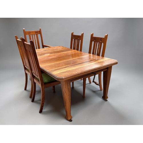 4 - A Victorian Arts & Crafts Oak extending dining table and Chairs.With original winder and two lea... 