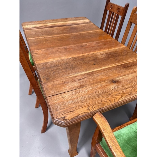 4 - A Victorian Arts & Crafts Oak extending dining table and Chairs.With original winder and two lea... 