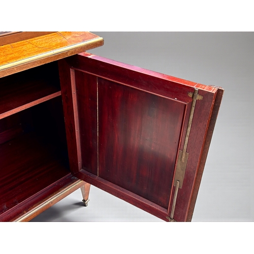 5 - A French Empire Walnut bookcase.Astragal glazed doors above two door cupboard. Ormolu mounted decals... 