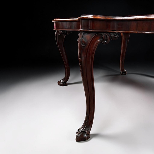 7 - A George III Rosewood centre / dining table.Early 19th century.Serpentine top, with carved legs and ... 