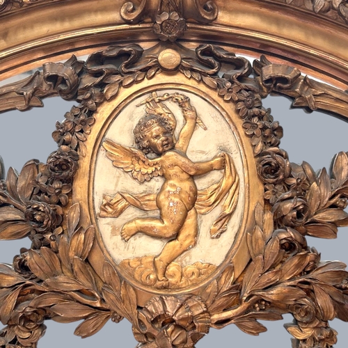 13 - A very large French Louis XVI Giltwood Trumeau mirror.Late 18th century.Central carved Putto motif a... 