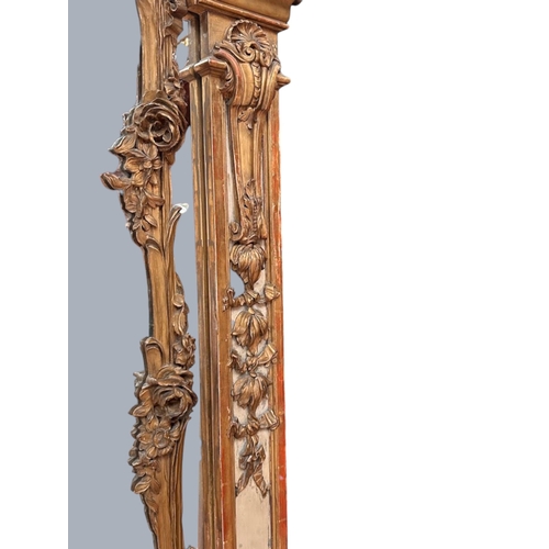 13 - A very large French Louis XVI Giltwood Trumeau mirror.Late 18th century.Central carved Putto motif a... 