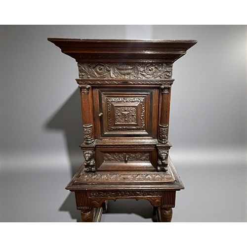 17 - A 17th/18th century Flemish cabinet on stand.Heavily carved Oak depicting foliate, vase and Lion dec... 