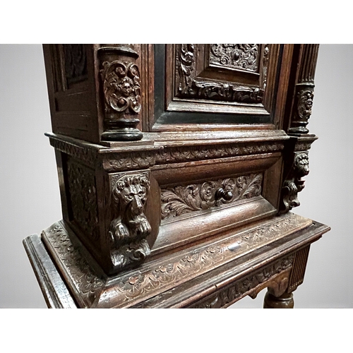 17 - A 17th/18th century Flemish cabinet on stand.Heavily carved Oak depicting foliate, vase and Lion dec... 