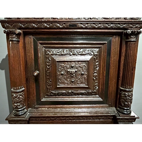 17 - A 17th/18th century Flemish cabinet on stand.Heavily carved Oak depicting foliate, vase and Lion dec... 