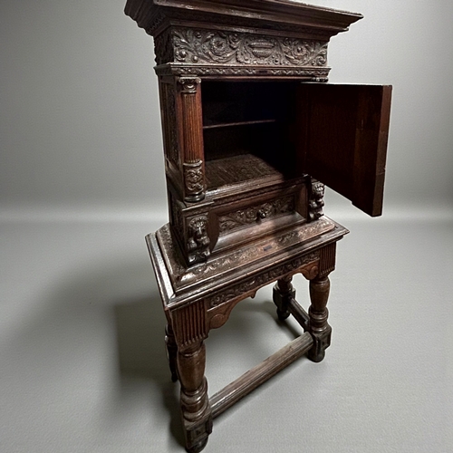 17 - A 17th/18th century Flemish cabinet on stand.Heavily carved Oak depicting foliate, vase and Lion dec... 