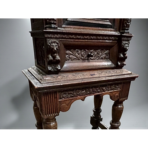 17 - A 17th/18th century Flemish cabinet on stand.Heavily carved Oak depicting foliate, vase and Lion dec... 