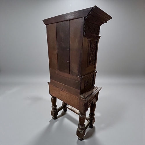 17 - A 17th/18th century Flemish cabinet on stand.Heavily carved Oak depicting foliate, vase and Lion dec... 