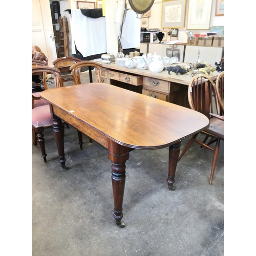 A mahogany table on 4 turned legs & casters, 28" high, 4'6" x 27"