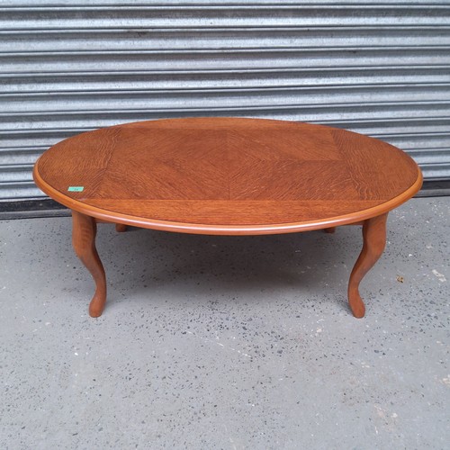 34 - Oval solid oak coffee table.