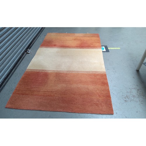 501 - Large woollen rug, cream and Terracotta. 150cm x 340cm.