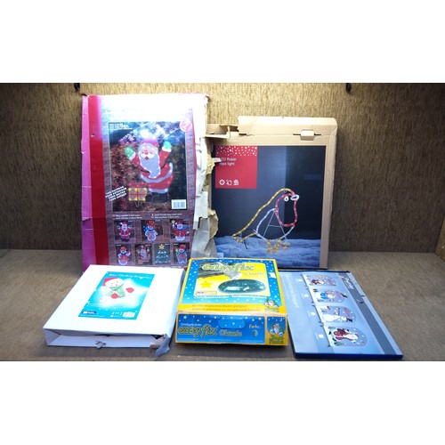 276 - Four light up Christmas decorations and a real Christmas tree base.