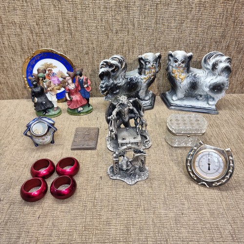 219 - Collectable items include a set of napkin rings, pewter dragons and a pair of fireside dogs.