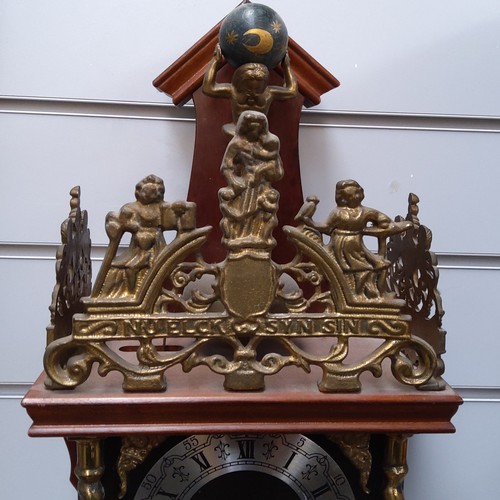 724 - A 1970s Zaanse wall mounted wooden and brass clock made in Holland.