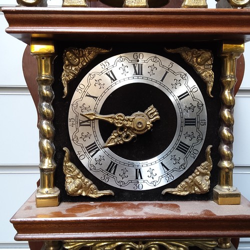 724 - A 1970s Zaanse wall mounted wooden and brass clock made in Holland.