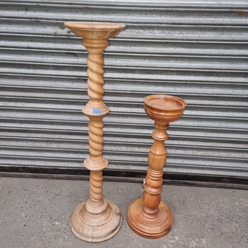 690 - Pair of tall standing pine plant stands 102cm and 72cm tall.