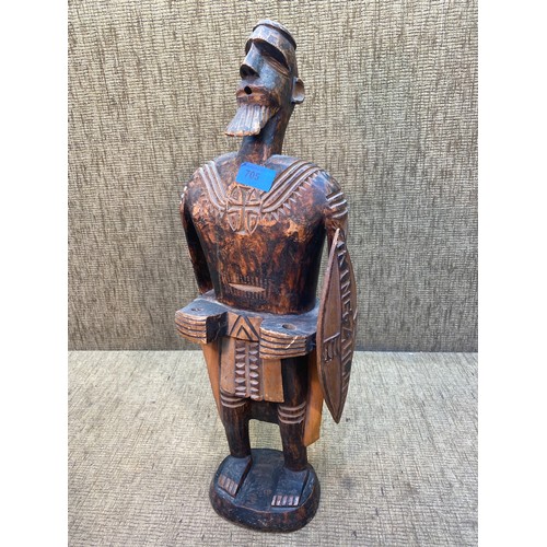 705 - A carved Tribal figure standing 60cm tall.