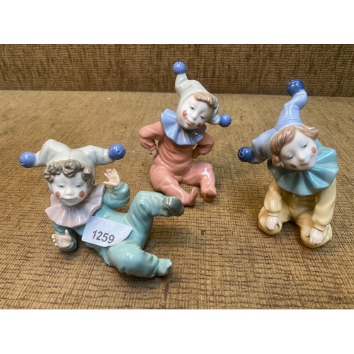 1259 - Three Lladro Nao Child jester figures 15cm tall.