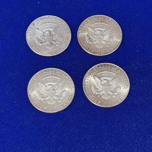 1066 - Four 900 silver 964 Kennedy Half Dollars.