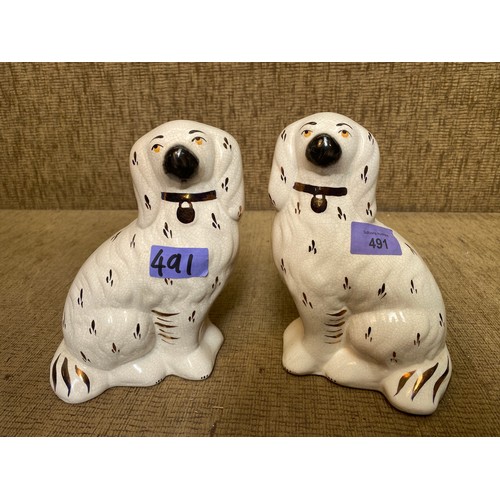 491 - Two Staffordshire fire side dogs.