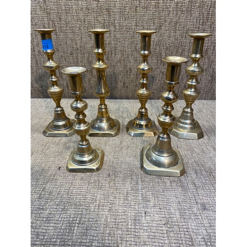 812 - 6 antique brass candle sticks.