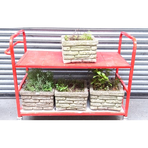 330 - 4 concrete planters.( trolley not included)