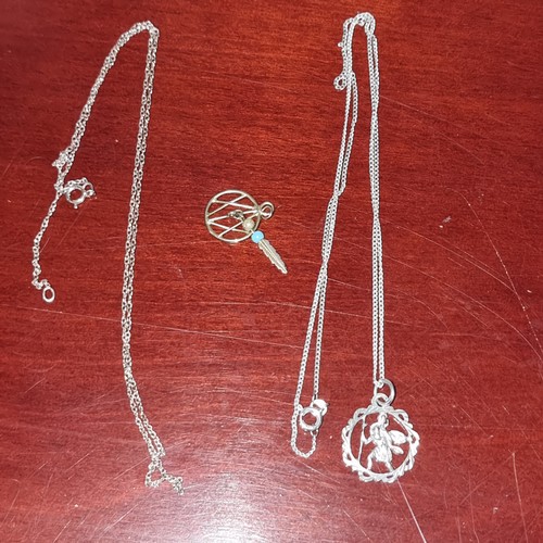 1047C - Two silver necklaces and a yellow metal dream catcher pendant.