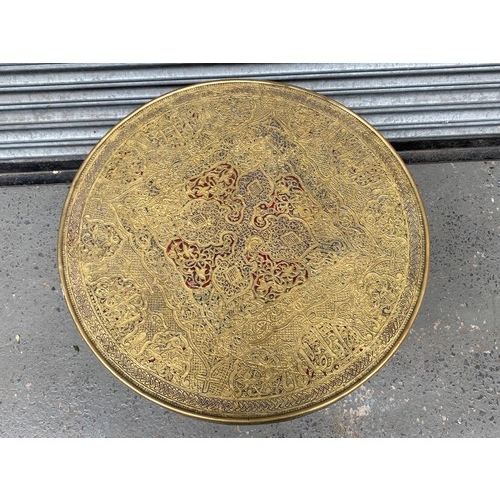 500 - Sculpted brass topped food away table. 60 cm diameter.