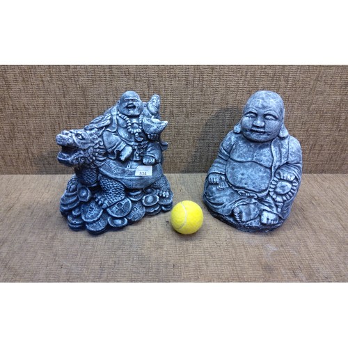 534 - Two medium sized concrete Buddha ornaments.