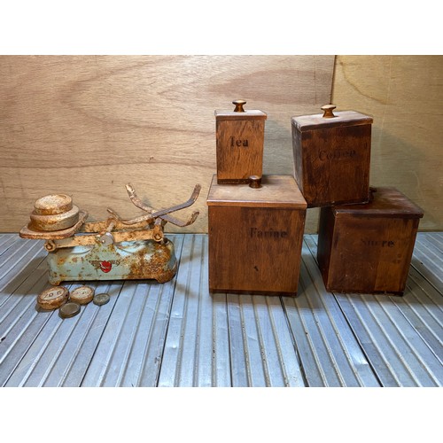 605 - Four dark wooden Tea, coffee and sugar containers and a set of vintage weighing scales.