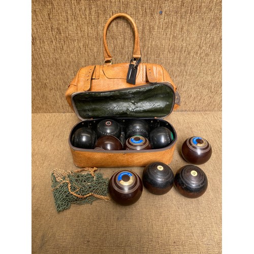 43 - Collection of lawn bowls in a leather case.