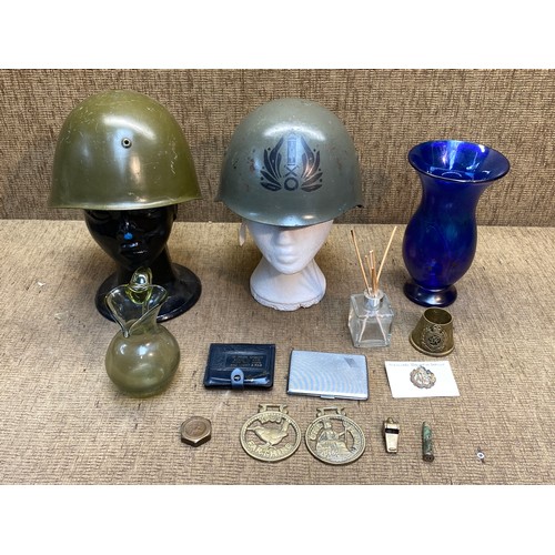 1121 - Two antique military helmets and a selection of military buttons and brass whistle.