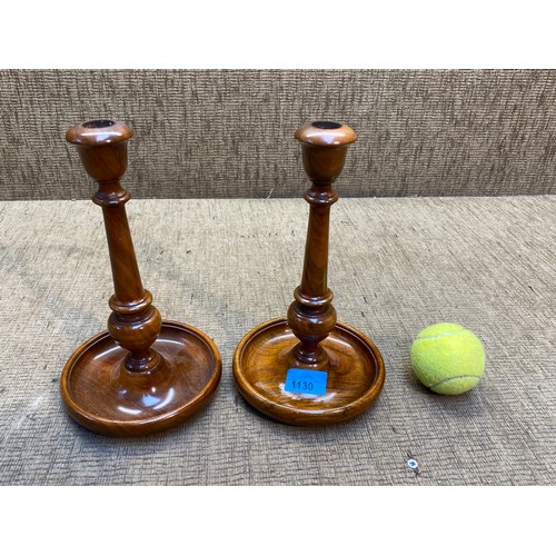 1130 - Pair of fruit wood pillar candle sticks.