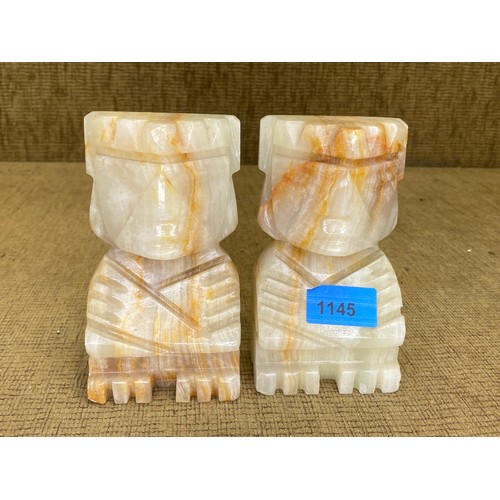 1145 - Pair of heavy marble Tiki bookends.