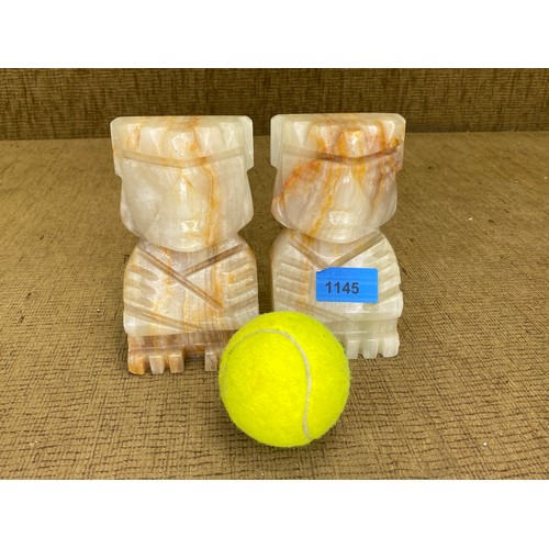 1145 - Pair of heavy marble Tiki bookends.