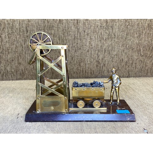 1184 - Brass minors wheel, and cart statue on wooden base.