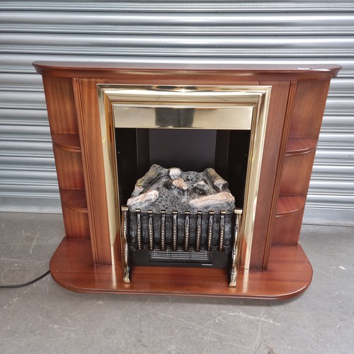 1229A - Brass and log effect fire with wooden surround.