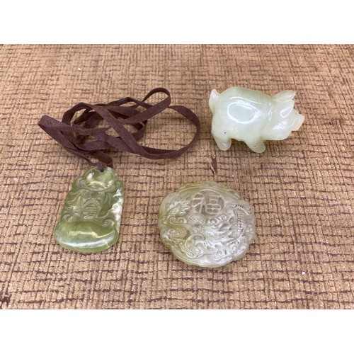 938 - Two jade pendants and a pig.