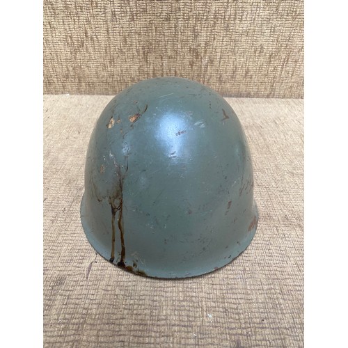 1121 - Two antique military helmets and a selection of military buttons and brass whistle.